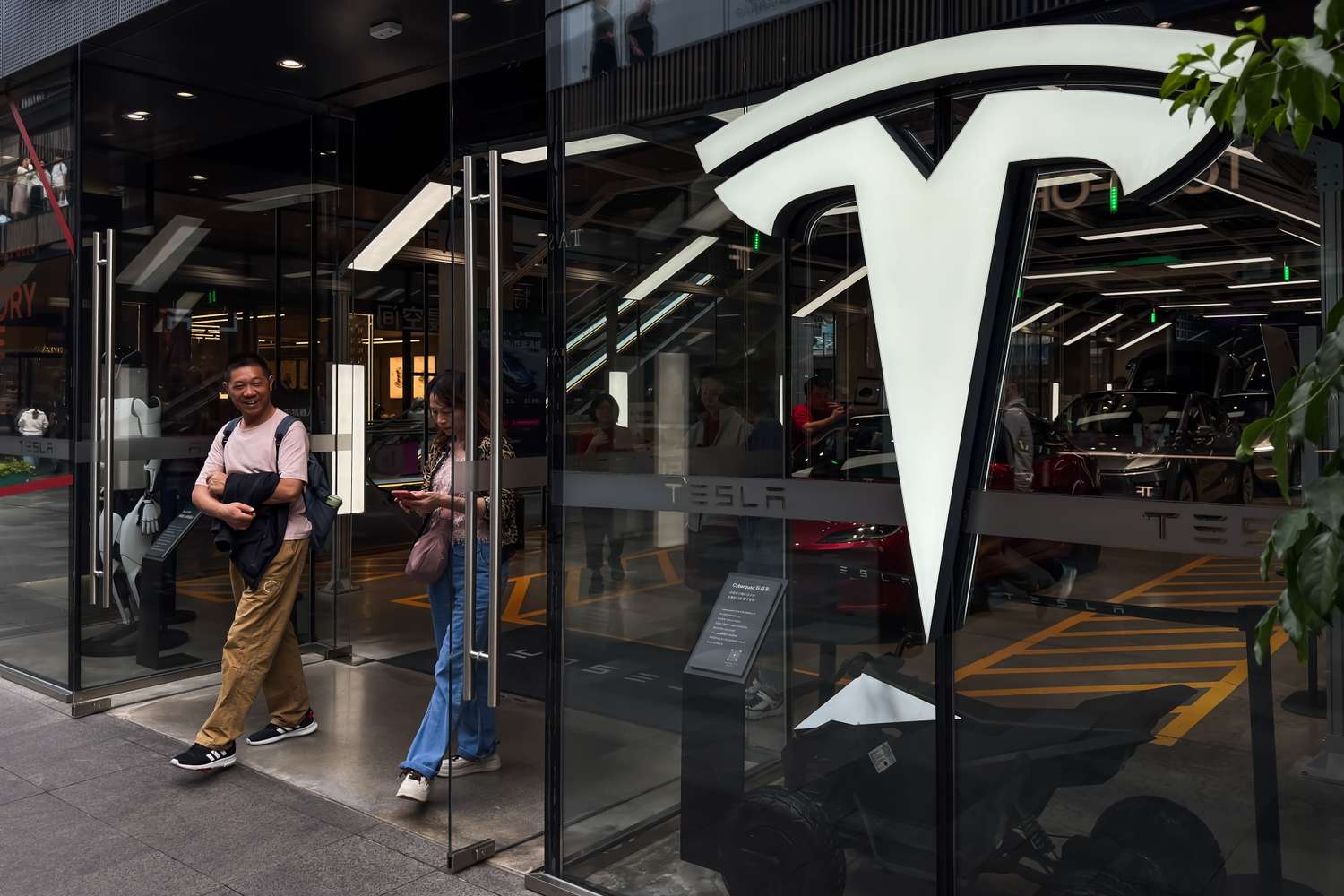 Visitors exit a Tesla store in Chengdu, China.
